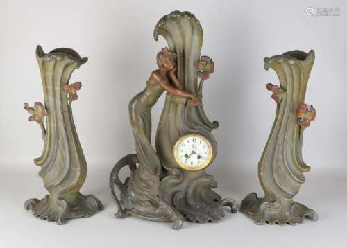 Large antique Jugendstil clock set with female figures.