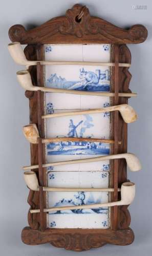 Antique pipe rack with terracotta pipes. Cut oak. Circa