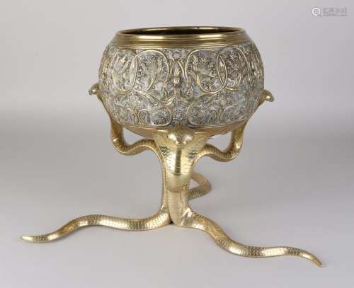 Oriental two-part brass flowerpot on cobra snake base.