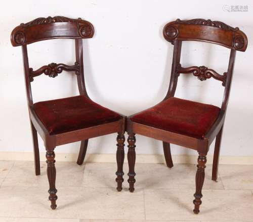 Four antique English mahogany chairs with carvings.