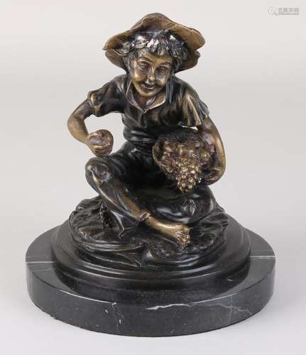 Bronze figure on black marble base. Boy with fruit