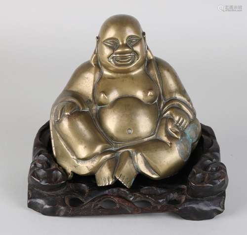 Ancient Chinese bronze Buddha on wood-burning base.