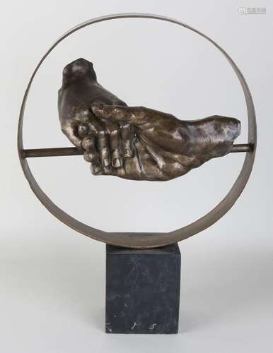 Large bronze sculpture on a black marble base. Two