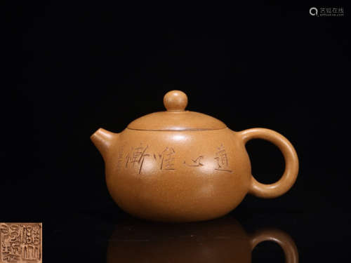 A ZISHA TEAPOT WITH BIRD PATTERN AND MARKING