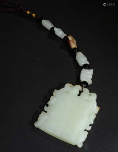 A HETIAN JADE PENDANT WITH BEAST PATTERNS