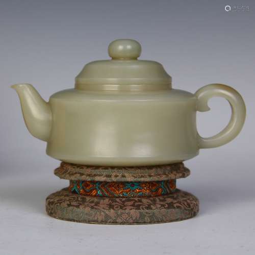 A Chinese Carved Jade Teapot With Stand