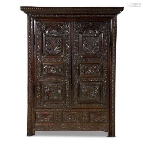 A BRETON CARVED OAK MARRIAGE ARMOIRE