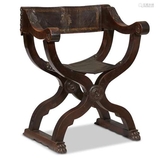 A SPANISH CARVED WALNUT CURULE CHAIR WITH TOOLED LEATHER UPHOLSTERY