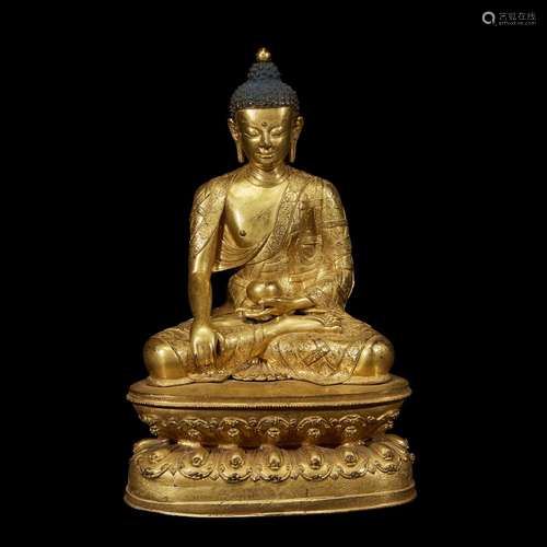 A FINELY CAST AND ENGRAVED TIBETAN GILT COPPER ALLOY FIGURE OF A SEATED BUDDHA