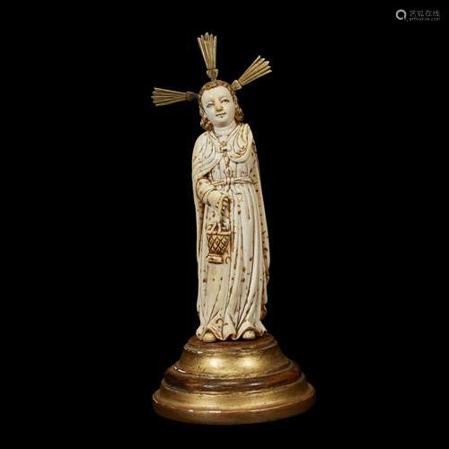 AN INDO-PORTUGUESE PARCEL-GILT CARVED IVORY FIGURE OF A SAINT