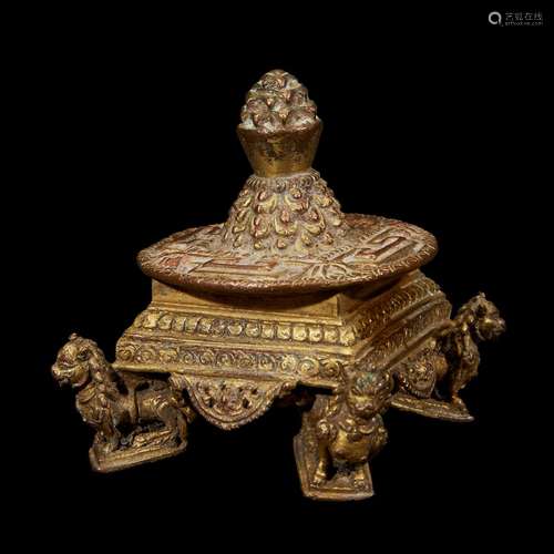 A NEPALESE GILT COPPER ALLOY SMALL MANDALA ON LION SUPPORTS