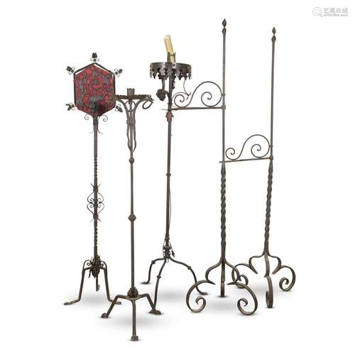 A GROUP OF FIVE WROUGHT IRON FLOOR LAMPS AND CANDLESTANDS