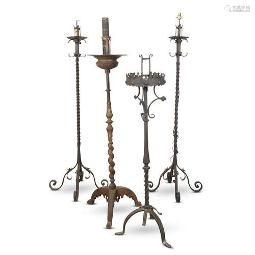 A GROUP OF FOUR WROUGHT IRON STANDING LAMPS