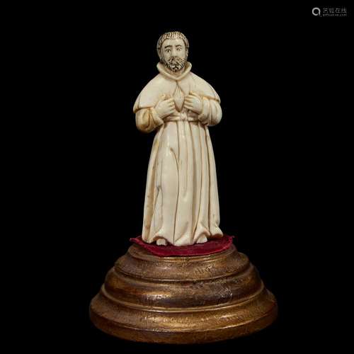 AN INDO-PORTUGUESE CARVED IVORY FIGURE OF A SAINT WITH FLAMING HEART