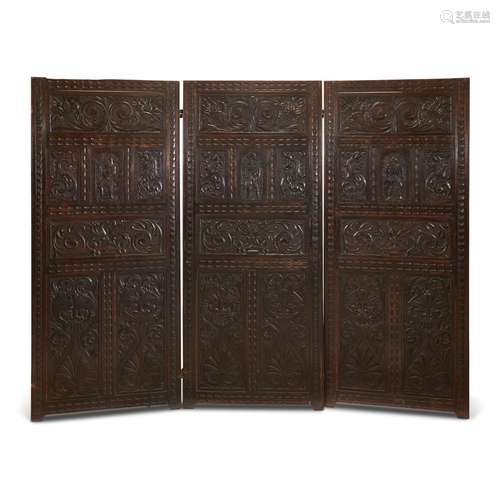 A JACOBEAN CARVED OAK THREE-PANEL FLOOR SCREEN