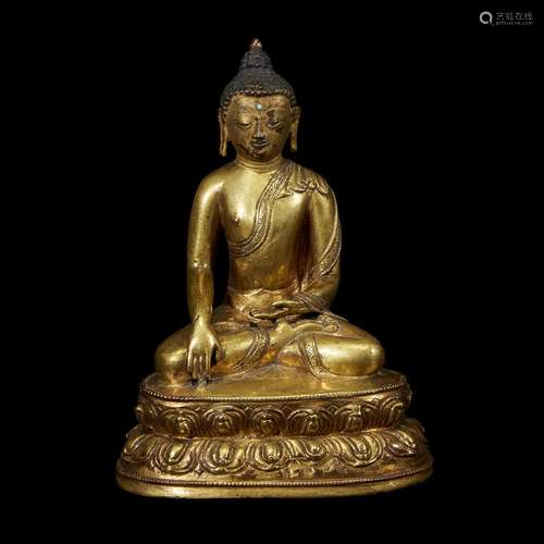 A TIBETAN GILT COPPER ALLOY FIGURE OF SHAKYAMUNI BUDDHA SEATED