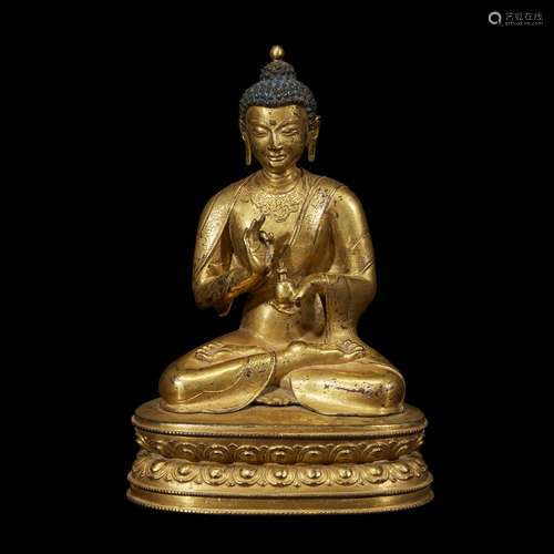 A FINELY CAST AND ENGRAVED SINO-TIBETAN GILT COPPER ALLOY FIGURE OF A SEATED BUDDHA