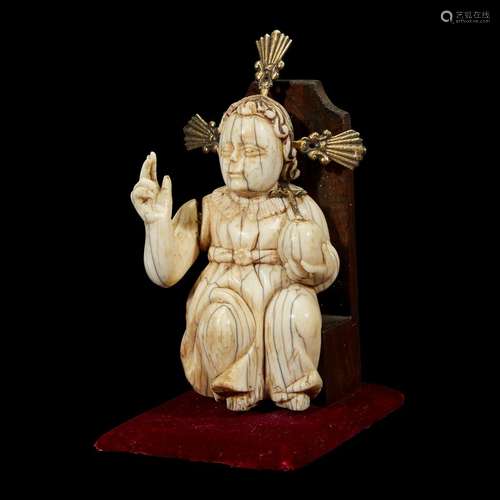 AN INDO-PORTUGUESE CARVED IVORY FIGURE OF THE CHRIST CHILD SEATED