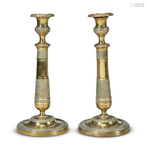 A PAIR OF FRENCH EMPIRE ENGINE-TURNED BRASS CANDLESTICKS