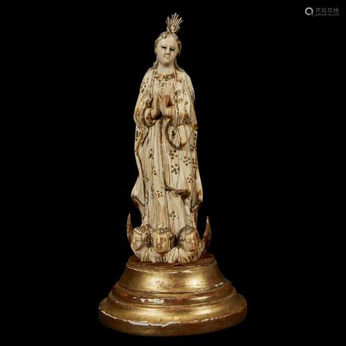 AN INDO- OR CEYLON-PORTUGUESE PARCEL-GILT CARVED IVORY FIGURE OF THE VIRGIN OF THE IMMACULATE CONCEPTION