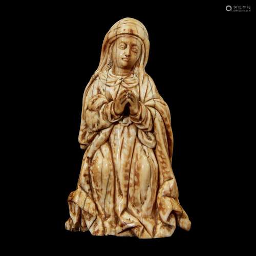 AN INDO-PORTUGUESE CARVED IVORY FIGURE OF THE MADONNA IN PRAYER