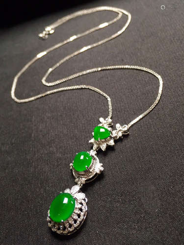 A CLAVICLE CHAIN NECKLACE WITH THREE GREEN GEMS