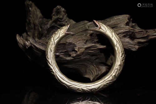 A SILVER DRAGON CARVED BRACELET