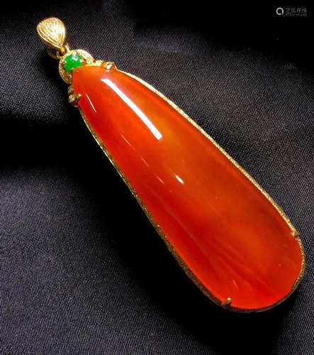 A RED JADEITE PENDANT OF PUMPKIN