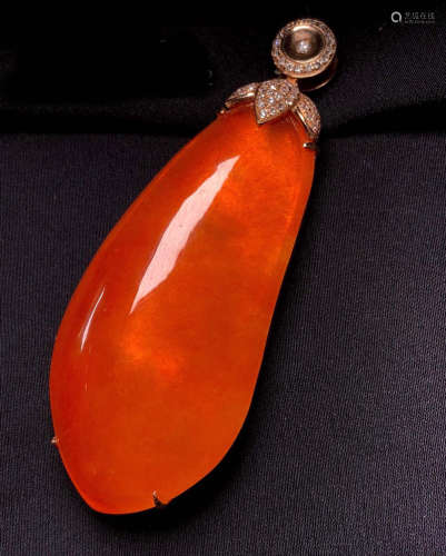 A NATURAL RED JADEITE PENDANT