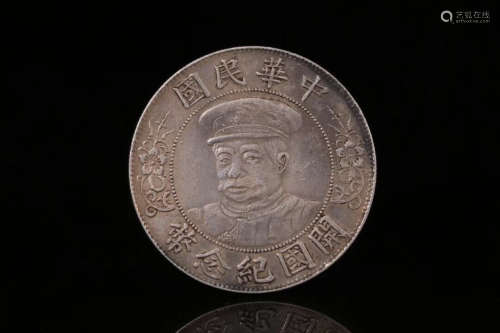 AN OLD SILVER COIN CARVED CHARACTER