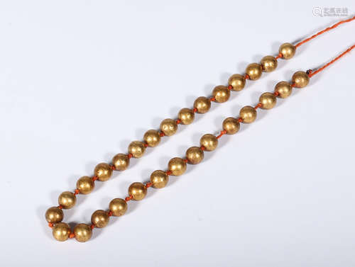 A STRING OF TIBETAN VERMILION BEADS