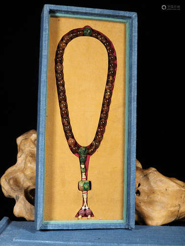 A STRING OF TOURMALINE BUDDHIST BEADS