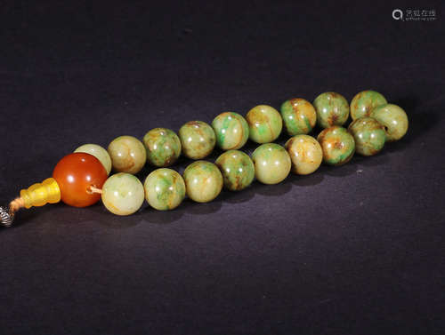 A STRING OF JADEITE BEADS