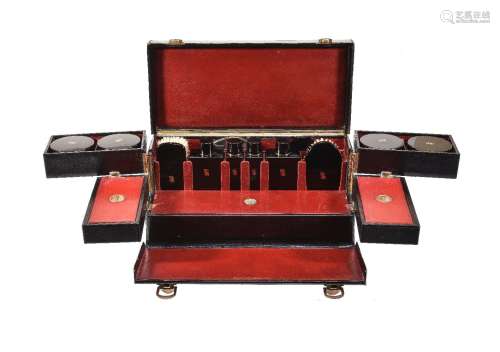 S. T. Dupont, a black leather travelling vanity case, 1930s, with a loop handle and brass clasps,