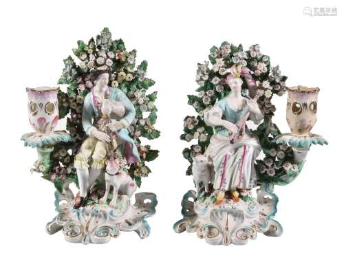 A pair of Derby porcelain figural candlesticks of a shepherd and companion, circa 1770, modelled