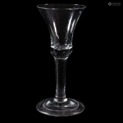 A large plain-stemmed wine glass, circa 1740, the bell bowl with solid basal section with bead