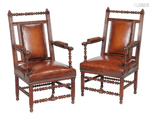 A pair of Reformed Gothic walnut and leather upholstered armchairs, circa 1870, in the manner of