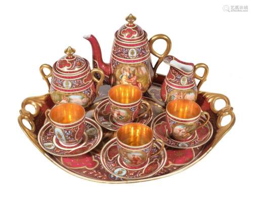 A Vienna-style claret and gilt ground part coffee service, circa 1900, decorated with titled
