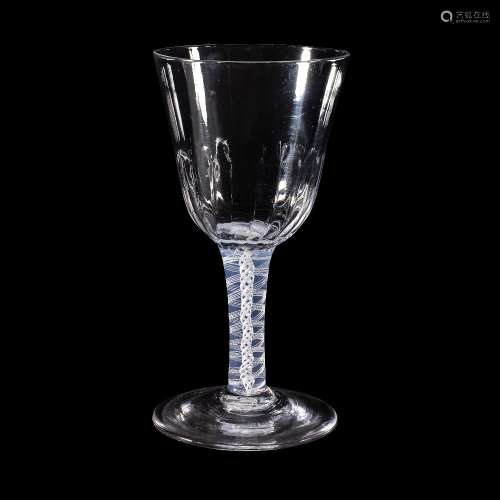 An opaque-twist wine glass, circa 1760, the round funnel bowl with a hammered flute basal section,