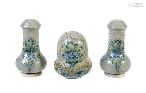 William Moorcroft for James Macintyre & Co., three Florian ware Cornflower pepper pots, circa