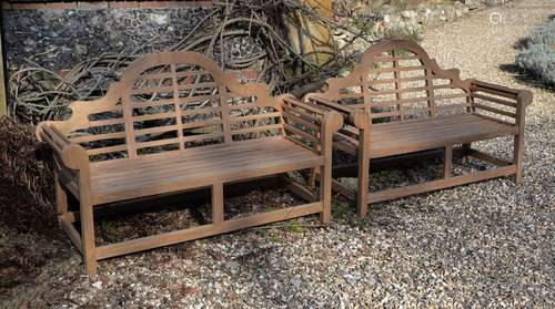 A pair of teak garden benches, of recent manufacture, in the manner of designs by Lutyens, the