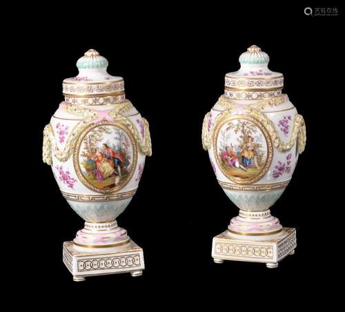 A pair of Dresden porcelain urns and covers, late 19th century, moulded with leaf and berry swags