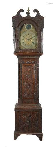 A carved oak longcase clock