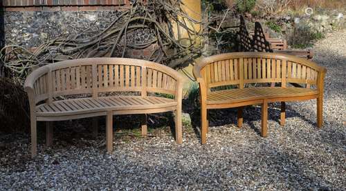 A pair of teak garden benches