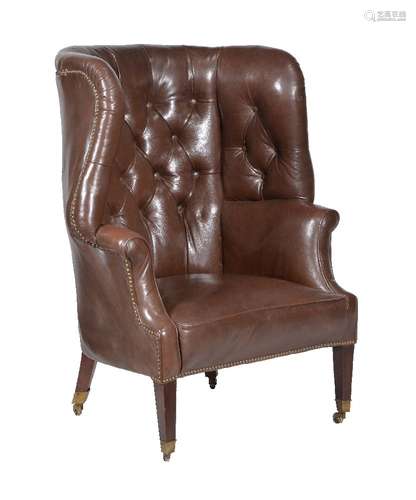 A George III mahogany and leather upholstered wing armchair