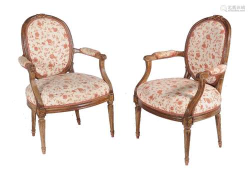 A pair of carved walnut and later upholstered fauteuils in Louis XVI style, 19th century