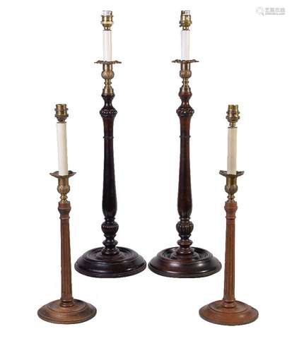 A pair of brass mounted stained mahogany table lamps modelled as George III style candlesticks