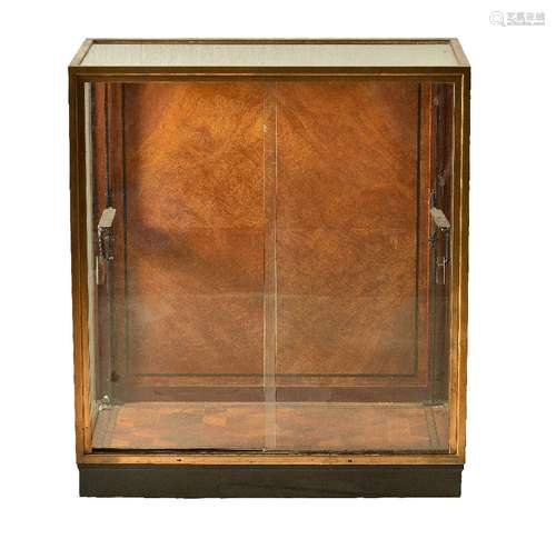 A brass framed and glazed shop display cabinet