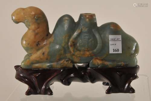 Jade incense holder. China. Early 20th century. Carving of a reclining camel. Green stone with tan markings. 5-1/2