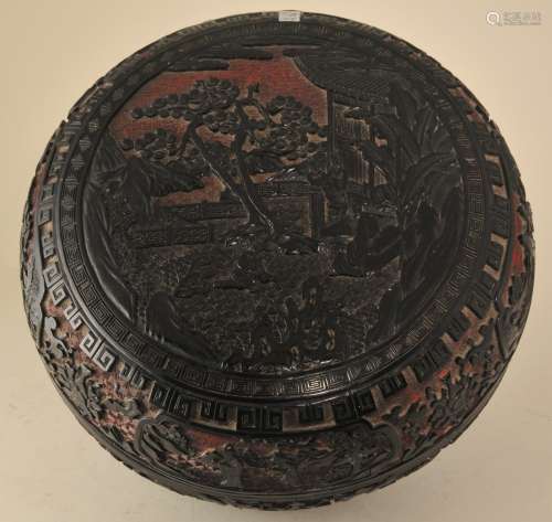 Cinnebar box. China. 19th century. Round form. Two colour type of black and red. Surface carved with figures in a landscape and lotus scrolls with various borders.  12